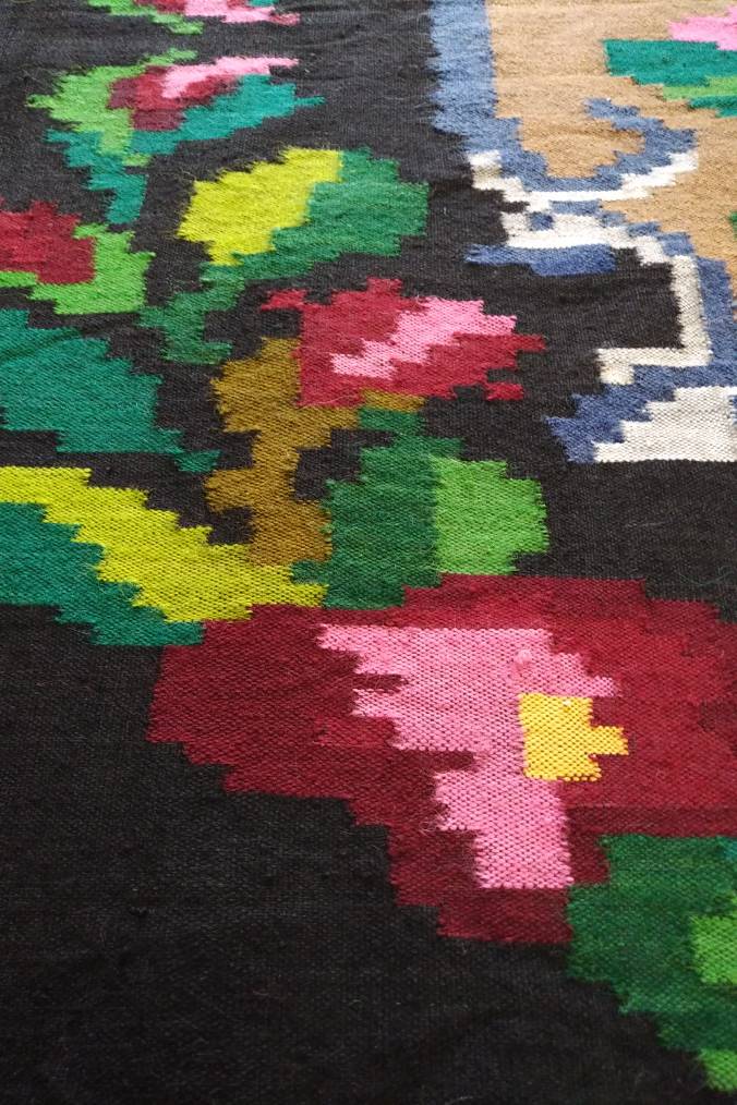 Romanian floral runner rug on blue background
