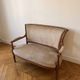 Louis XVI style antique canapé in wood and beige fabric.