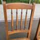 Solid wood chair with a straw seat and carved bar backrest.