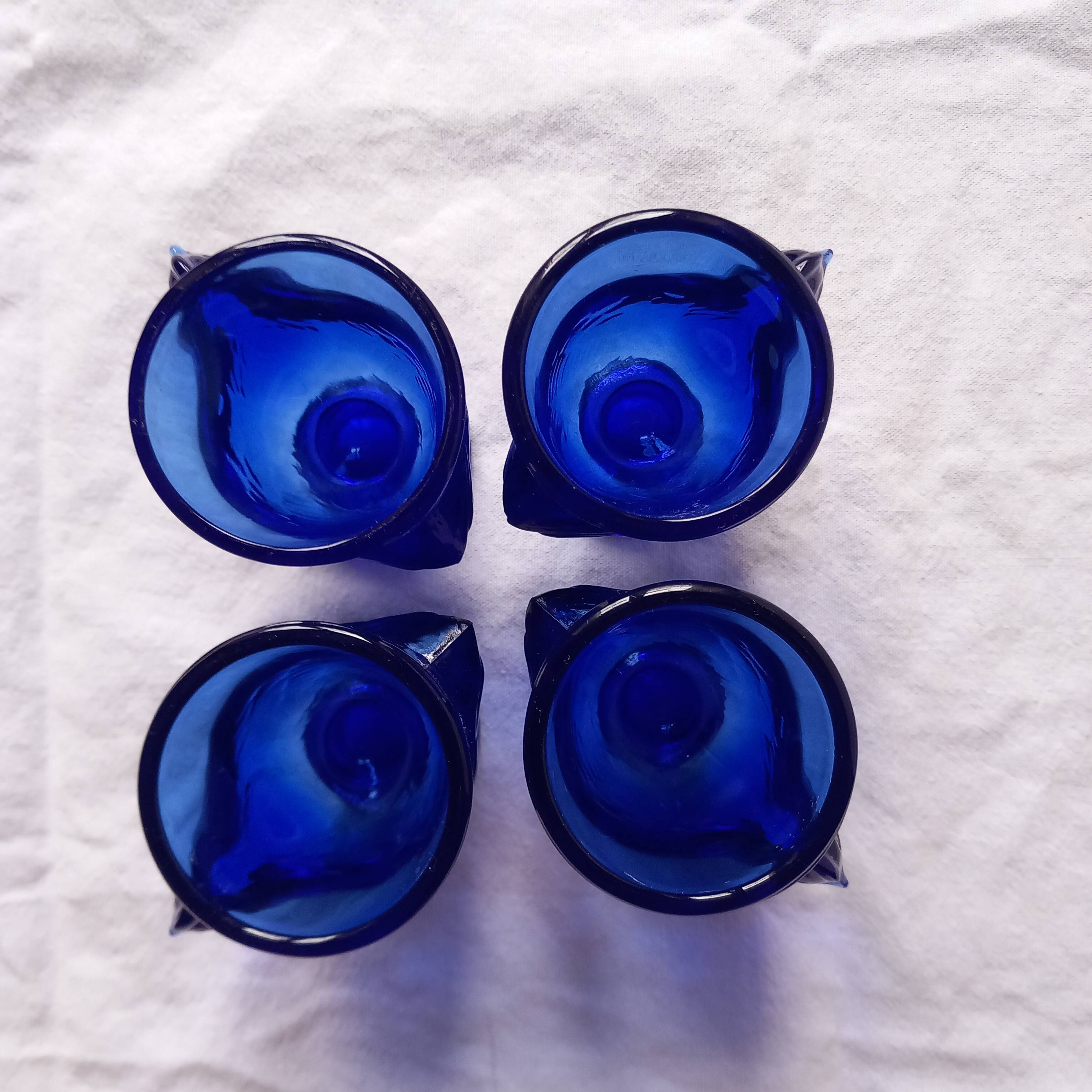 4 chicken-shaped egg cups in cobalt blue glass