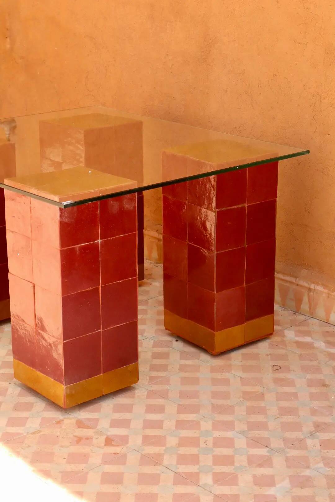 Modern coffee table in burgundy zellige with a tempered glass top.
