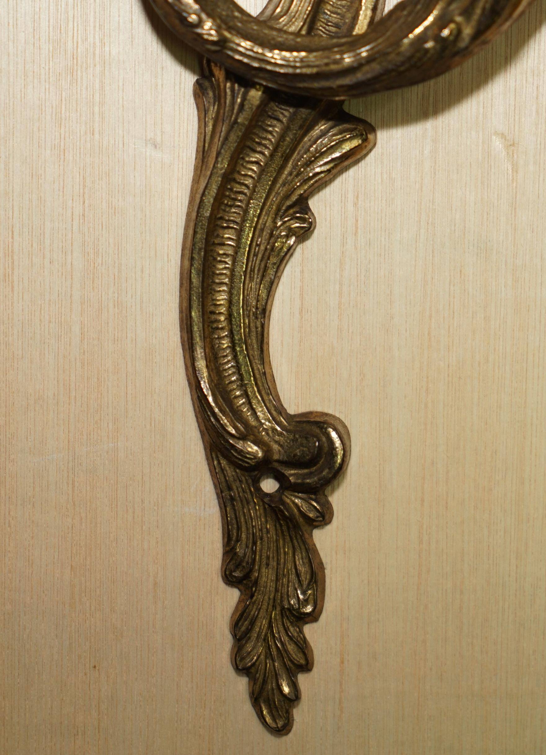 Pair of antique wall sconces from the 1920s in gilded bronze.