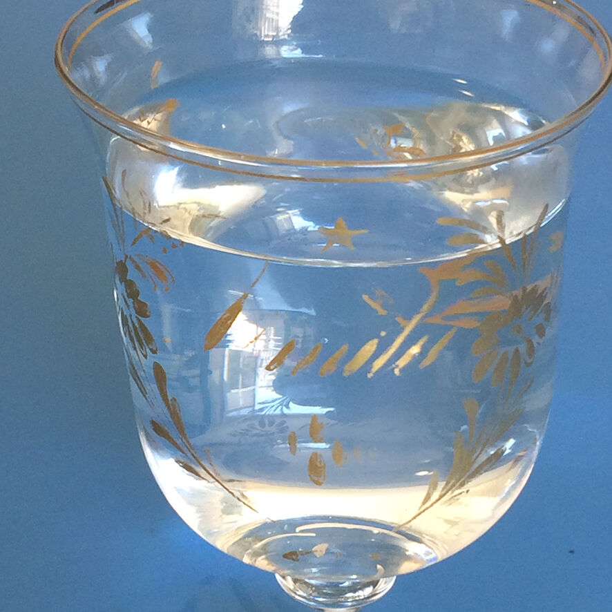 Two antique walking glasses with gold-painted floral decoration