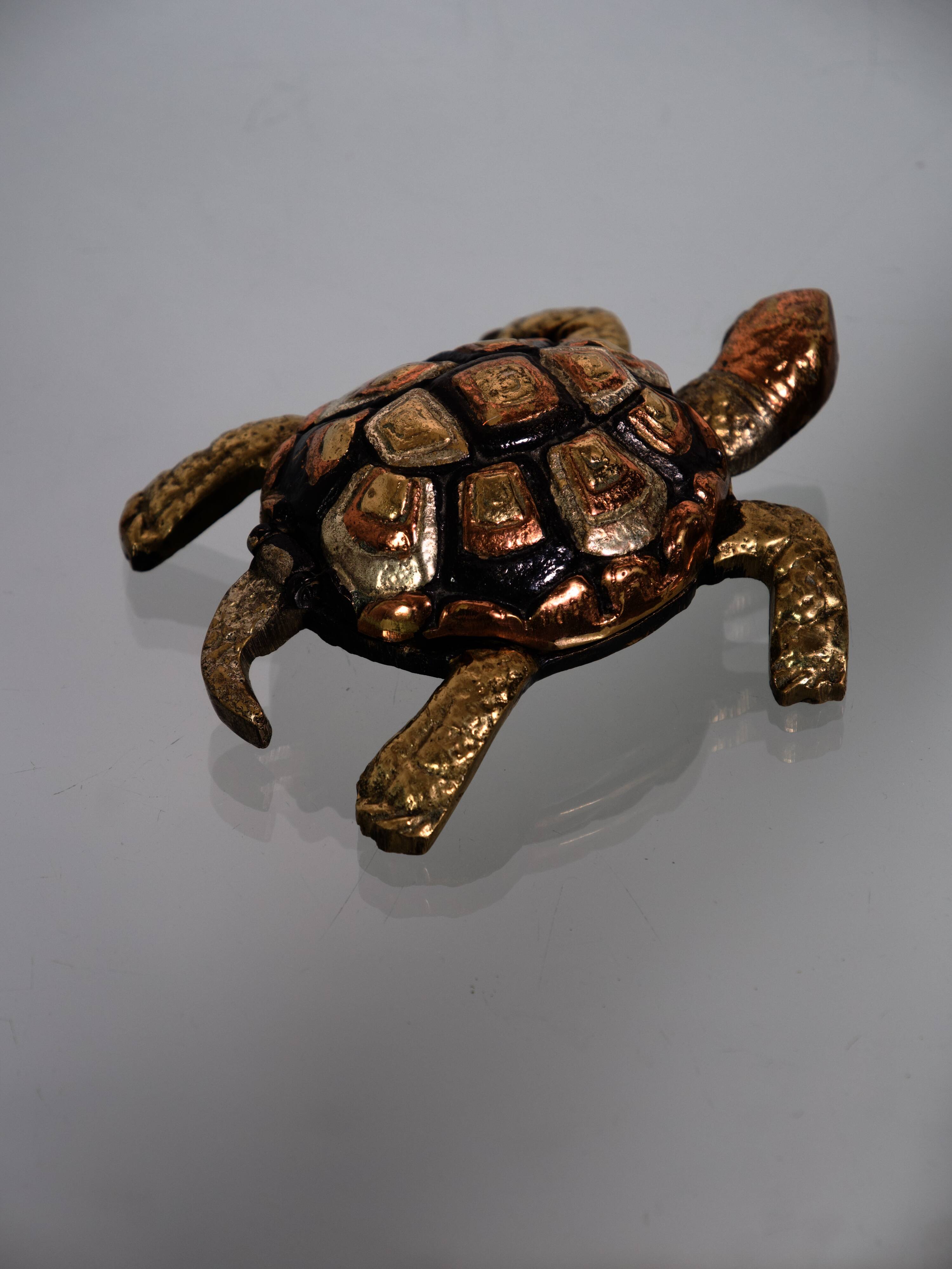 Golden brass turtle in decorative ashtray