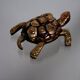 Golden brass turtle in decorative ashtray