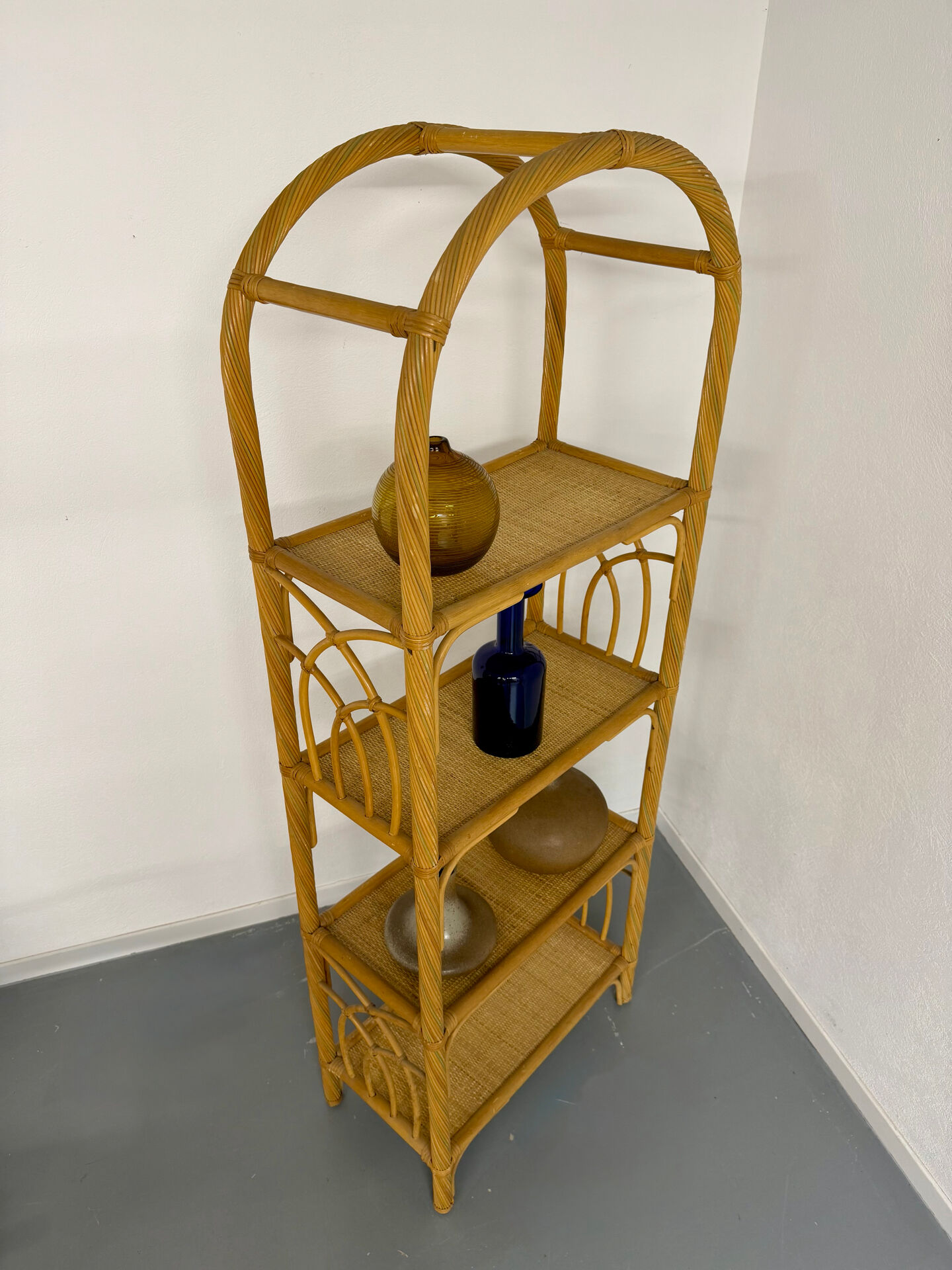 Large woven rattan bookshelf designed in the 1970s.
