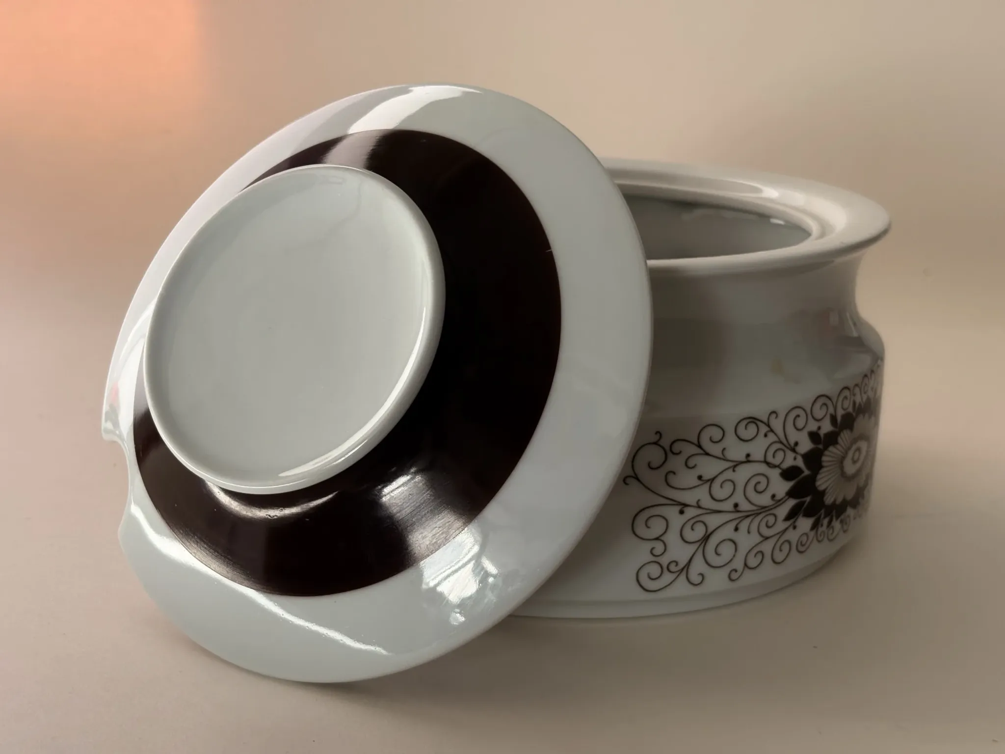 Porcelain soup tureen by Winterling, decorated with brown flowers.