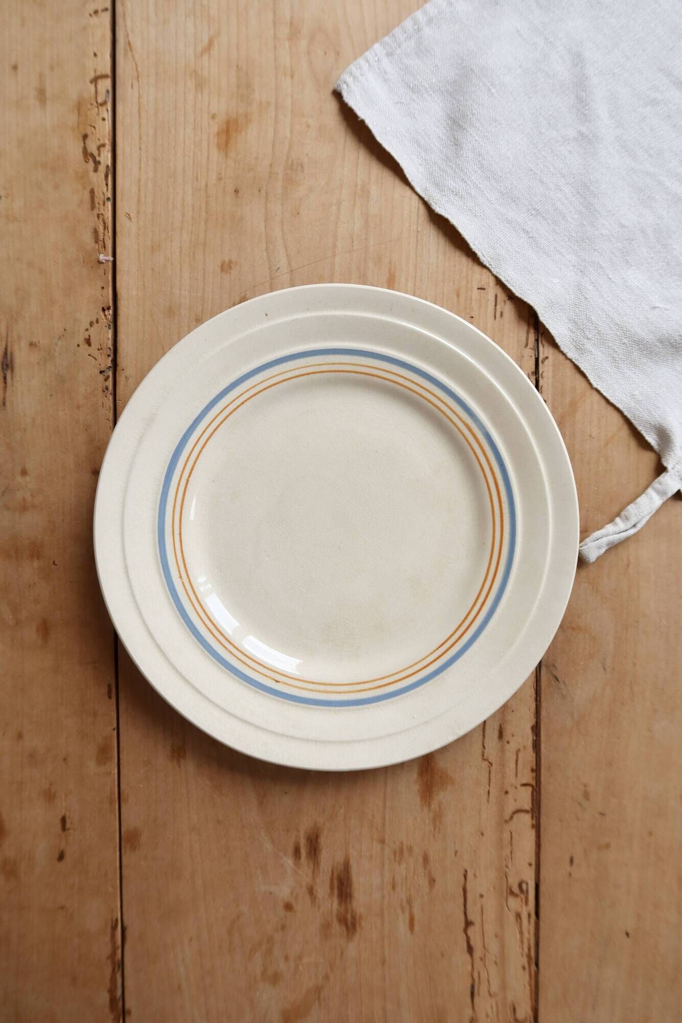 Ivory ironstone dessert plate – Pale blue and orange borders
