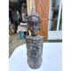 African statue of a woman, made of wood, brass, beads, and seashells.