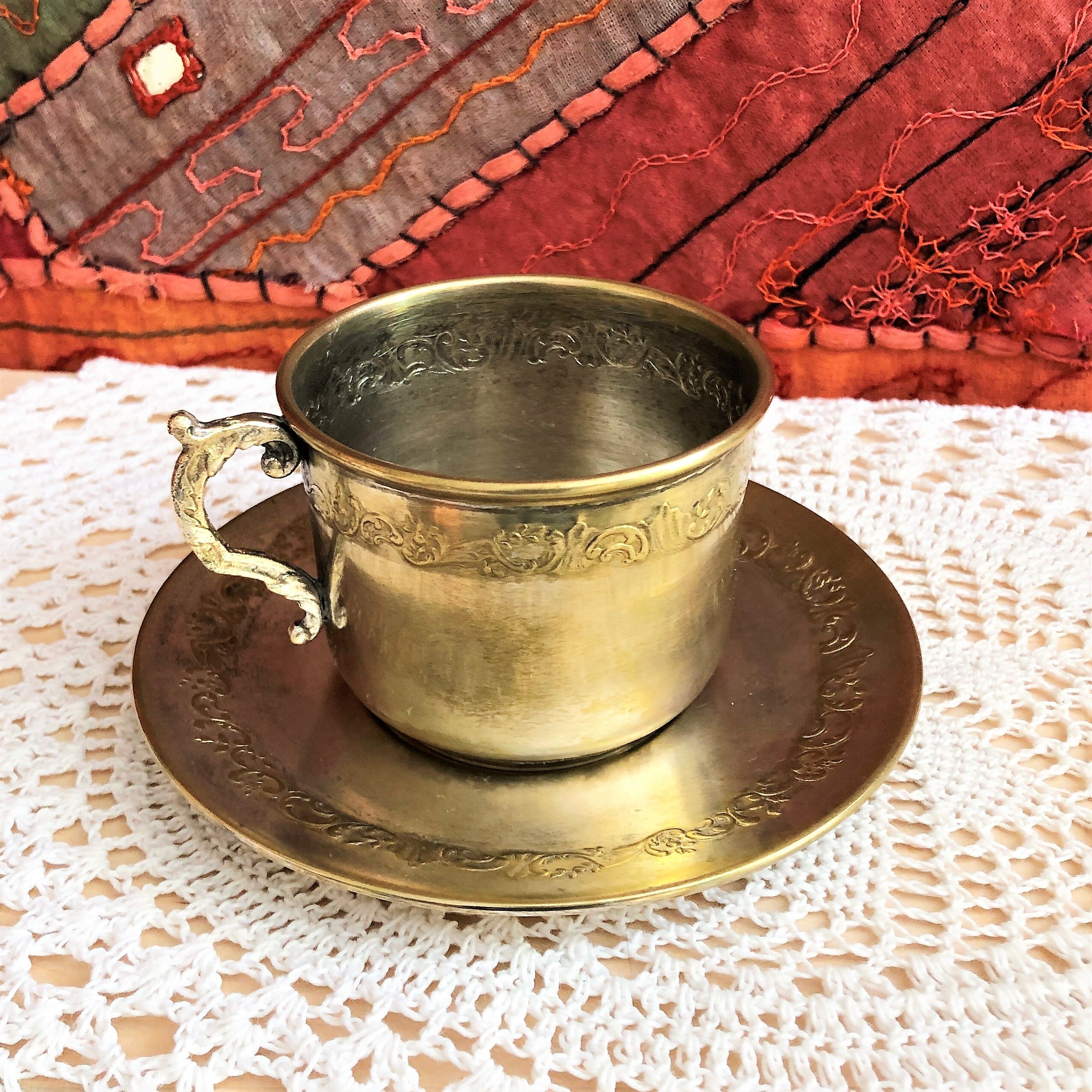 Silver metal cup and saucer