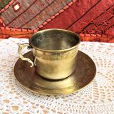 Silver metal cup and saucer