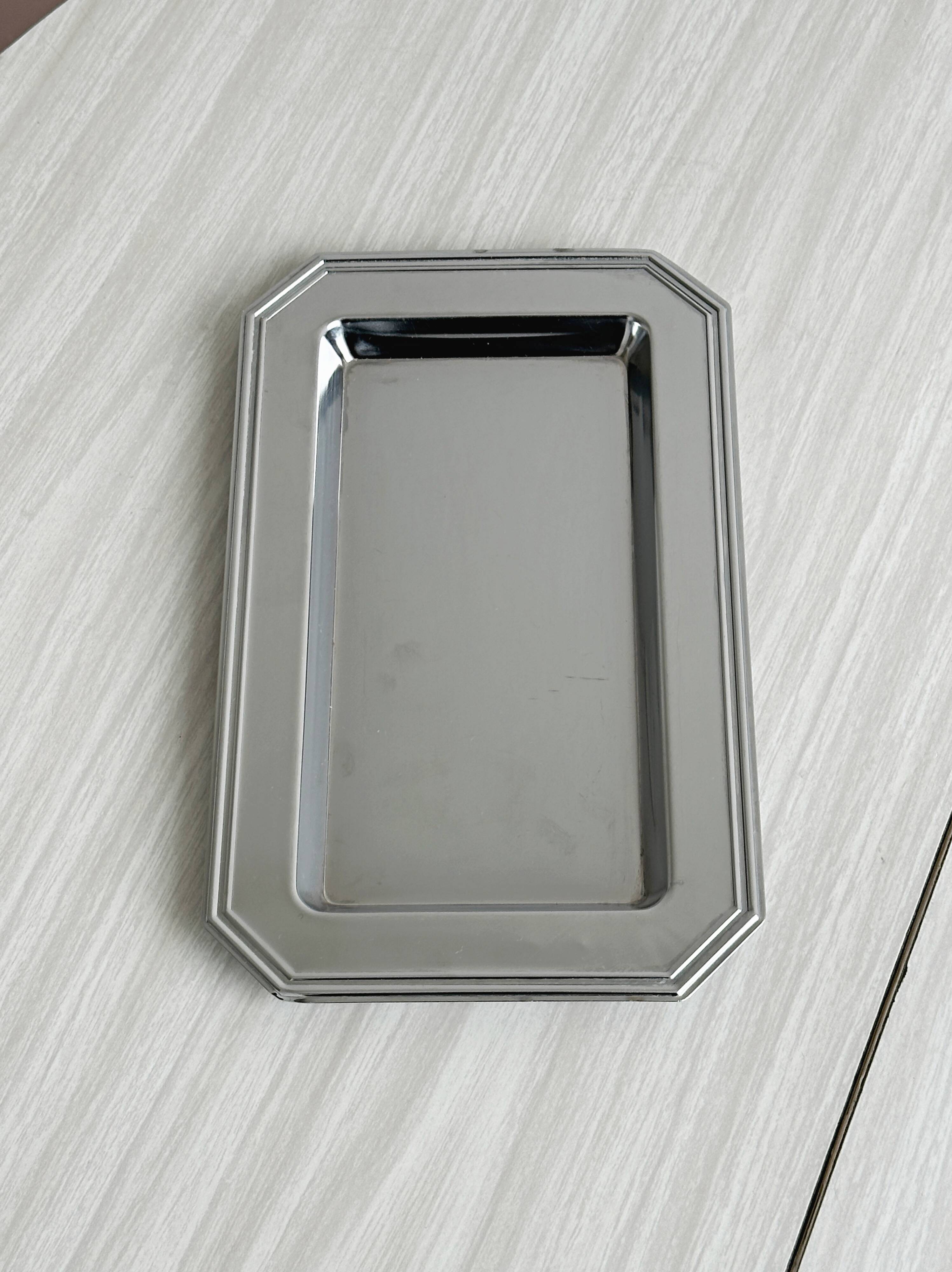 Small rectangular tray made of lightweight metal.
