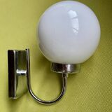 Pair of chrome metal wall lights with white glass globe.