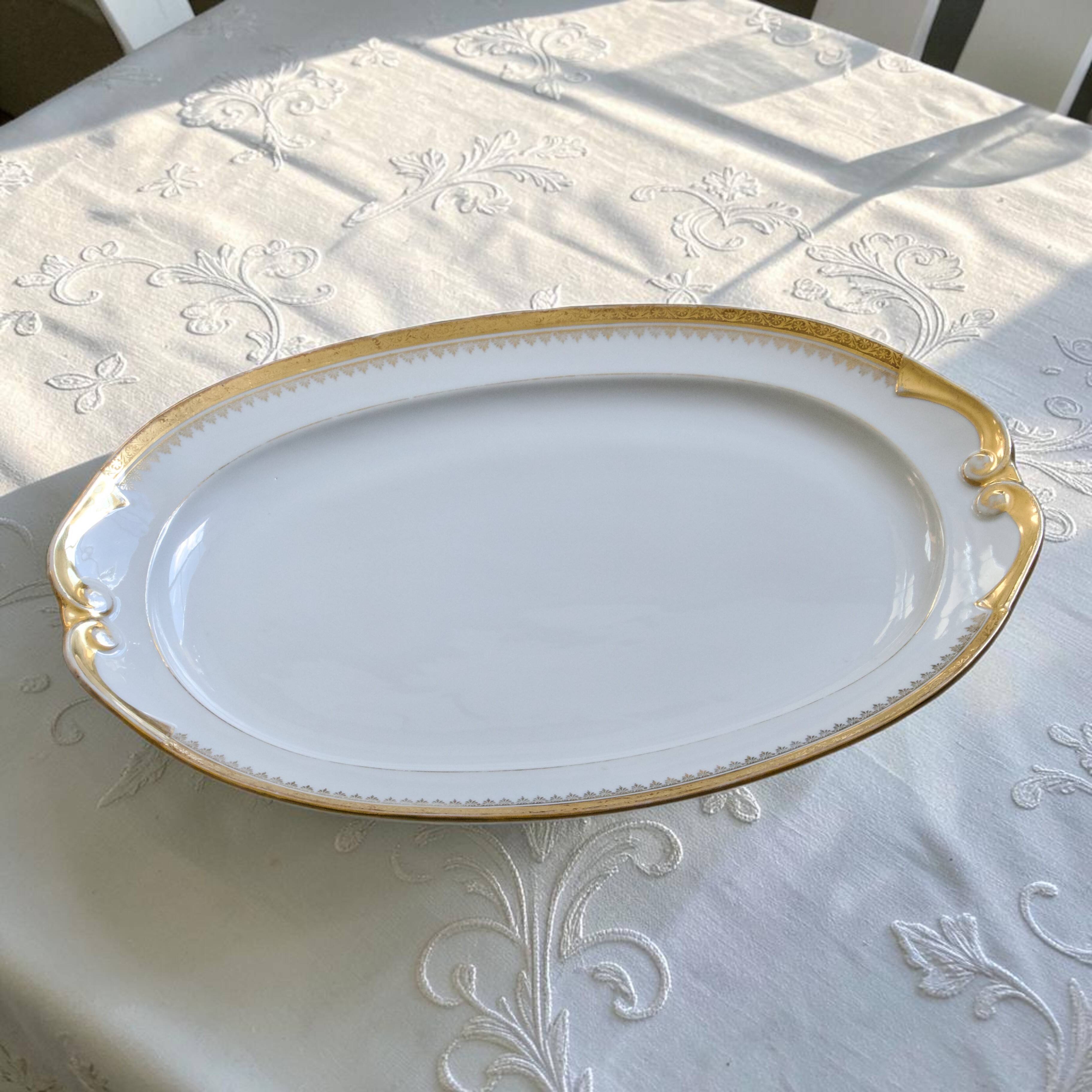 Very large oval dish with gold trim in Limoges porcelain by Peconnet.