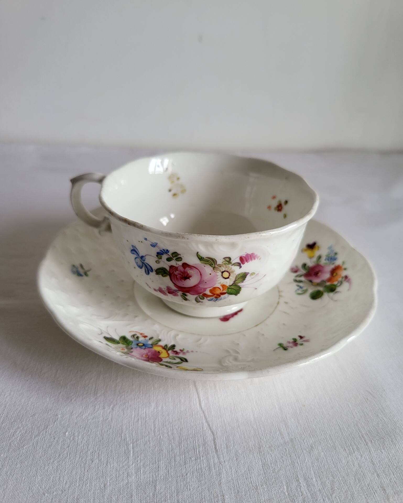 Antique Cup and Saucer in Porcelain with Hand-Painted Floral Decoration