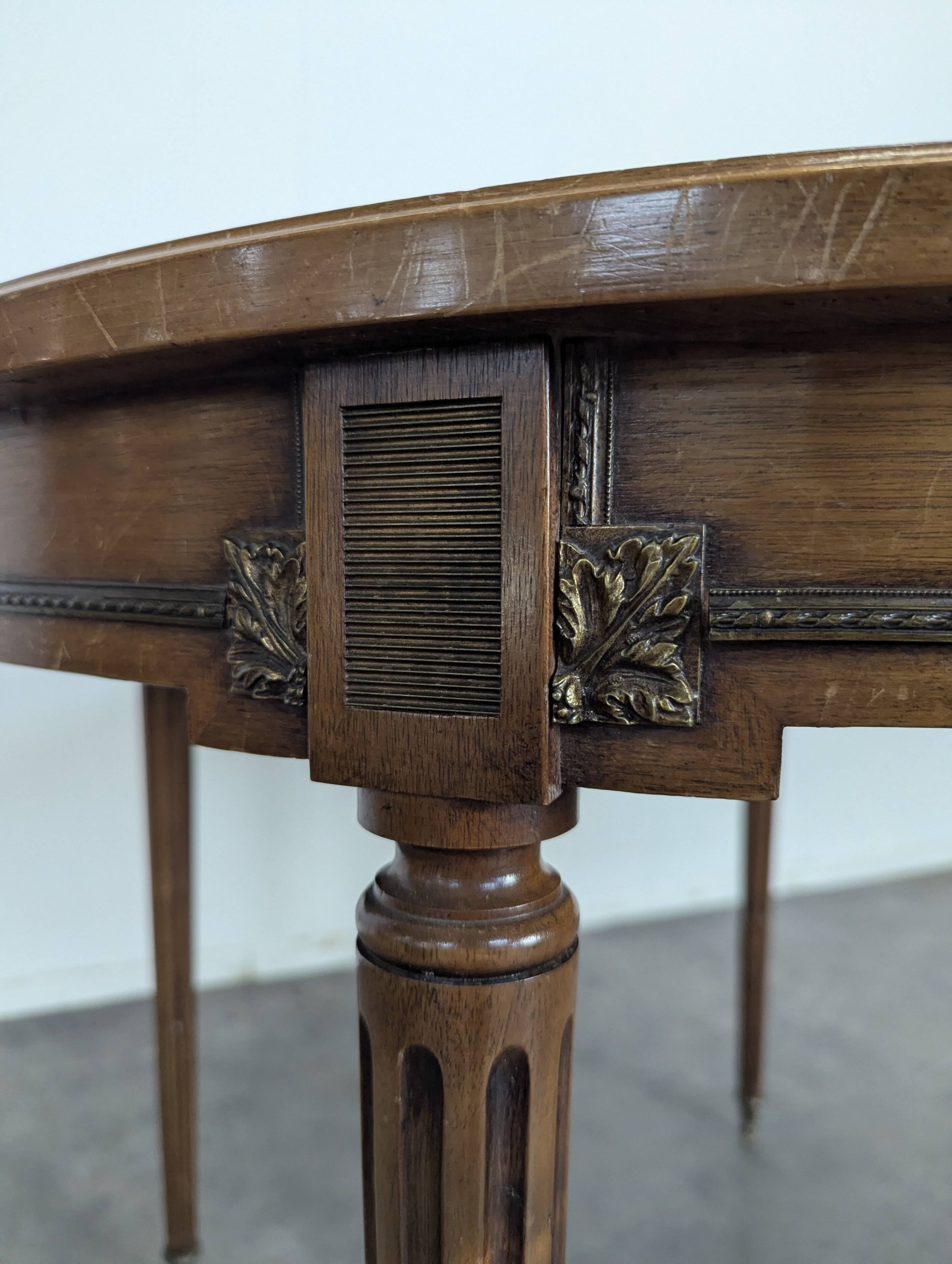 Louis XVI style dining table with a leather top.