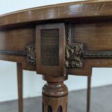 Louis XVI style dining table with a leather top.