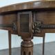 Louis XVI style dining table with a leather top.