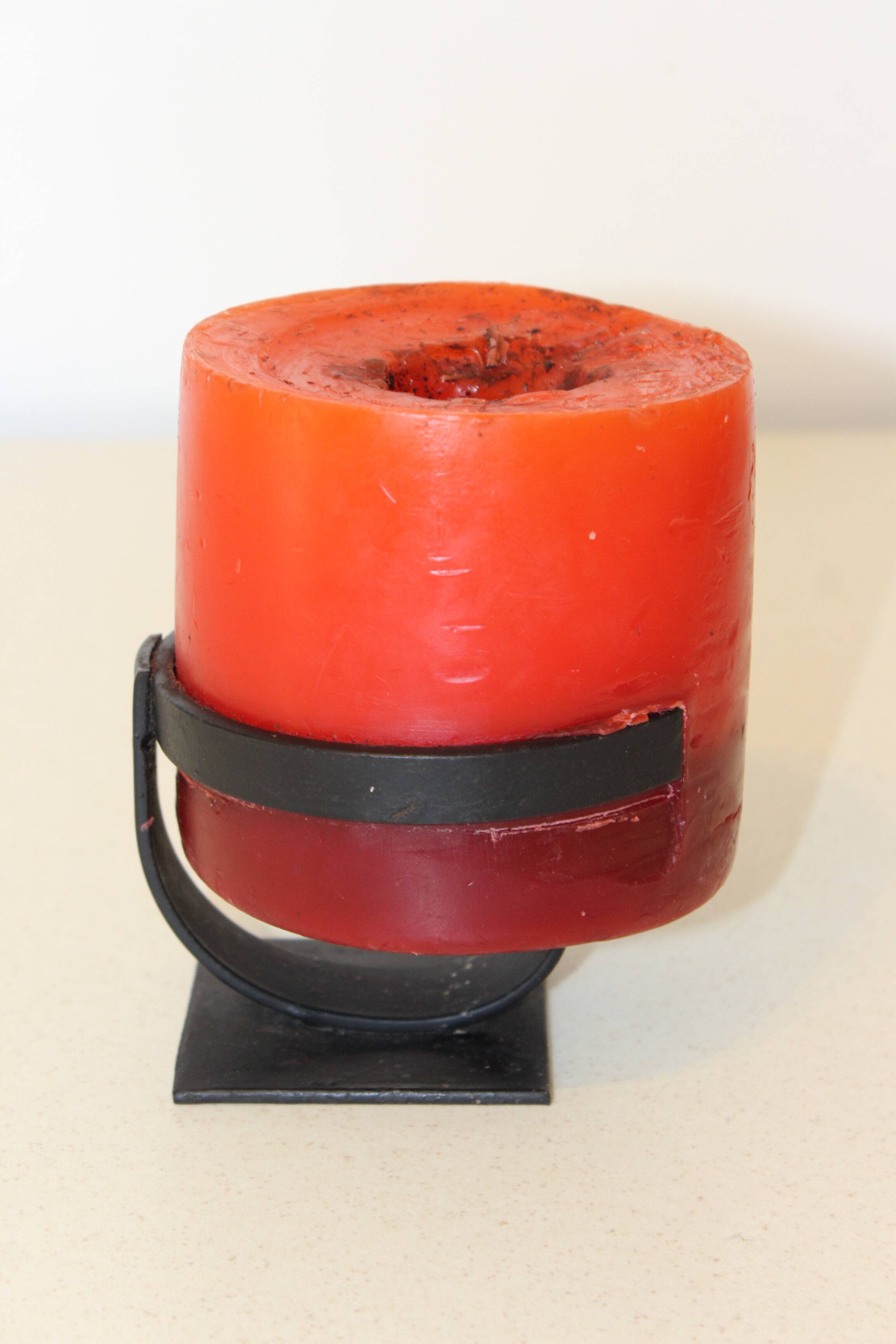 1970 wrought iron candlestick with its period coloured candle.