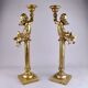 Pair of large candlesticks with cherubs