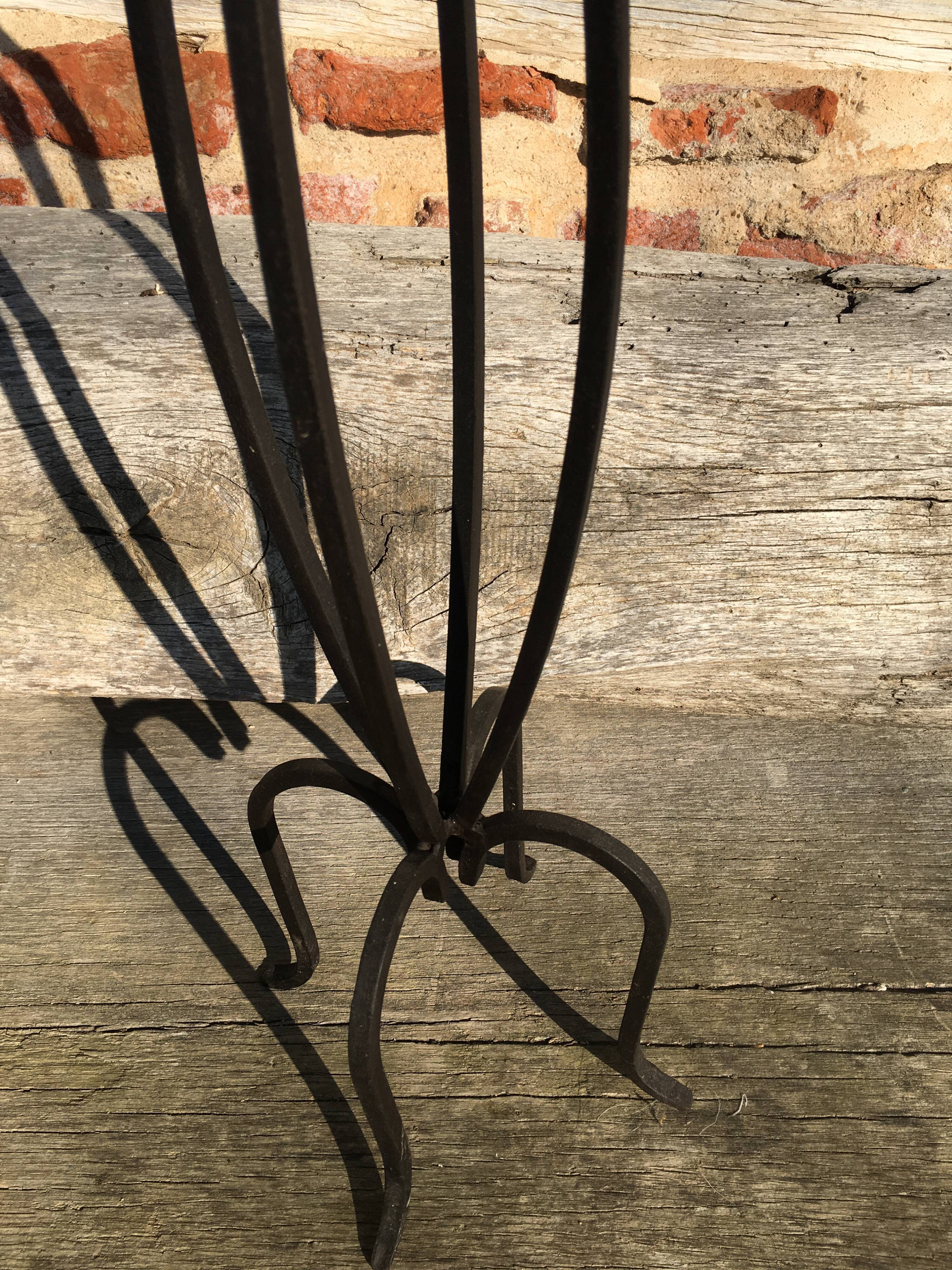 Wrought iron candlestick on feet