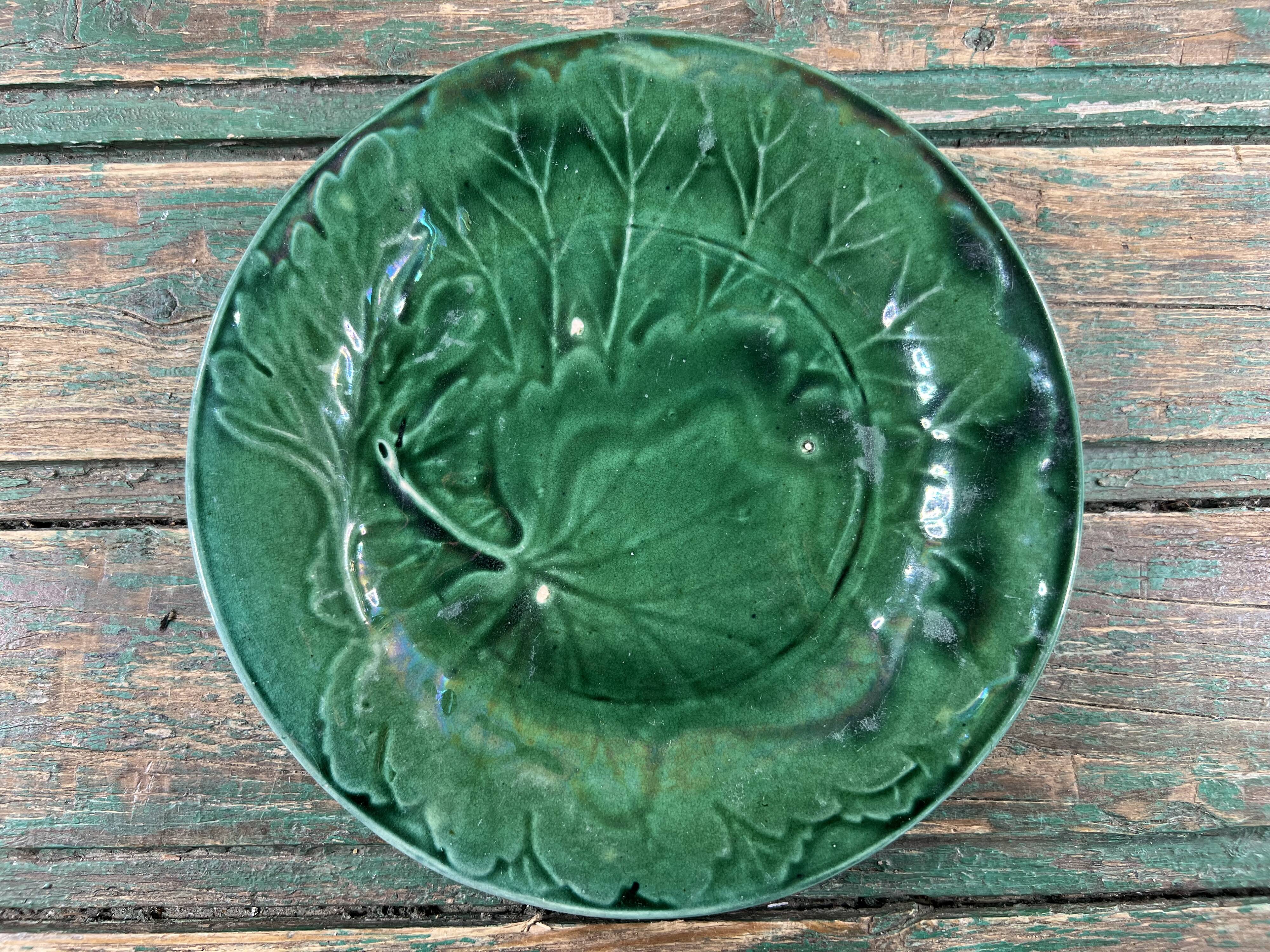Pair of green slip plates with leaf decoration, 19th century