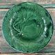 Pair of green slip plates with leaf decoration, 19th century