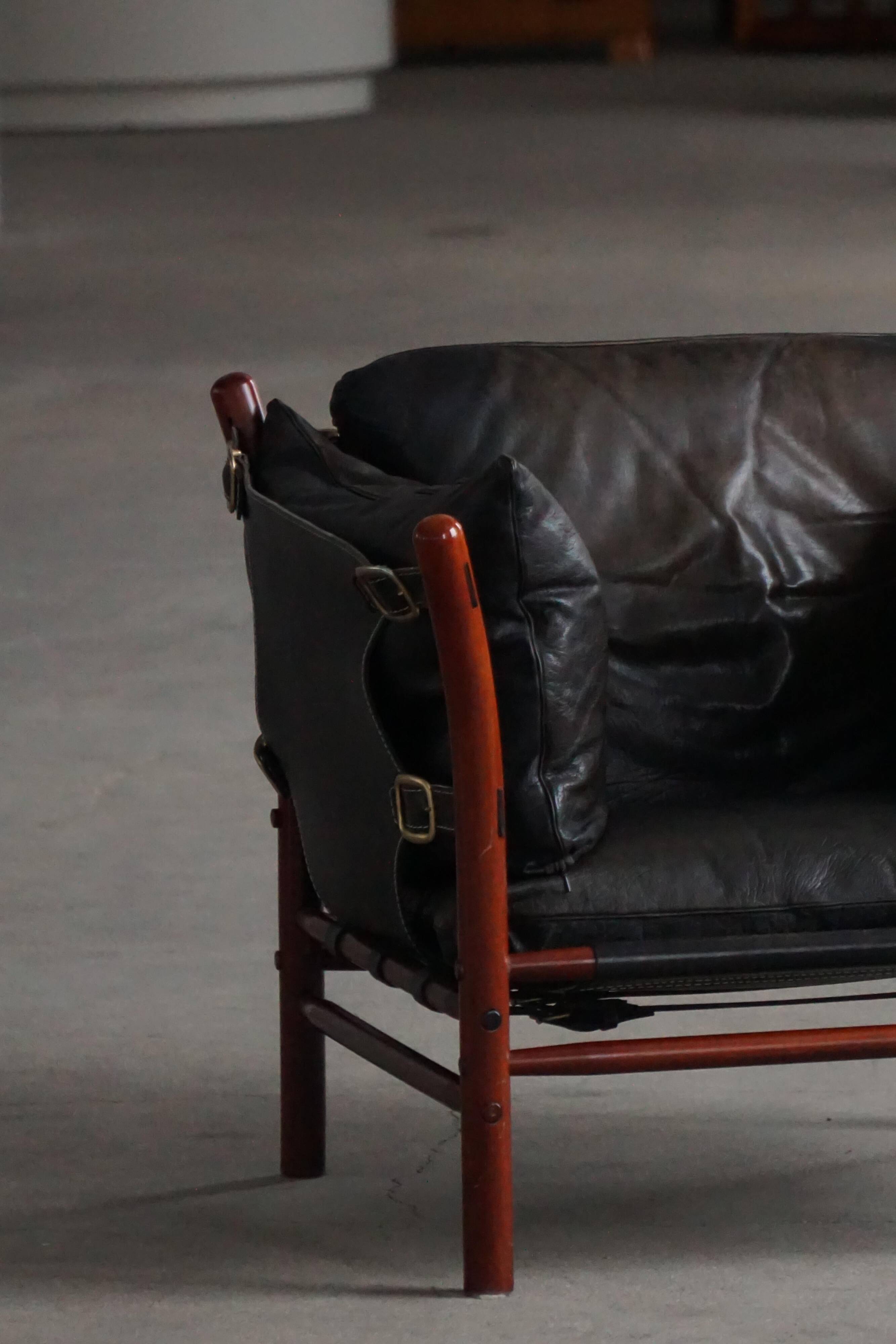 "Lounge chair 'Ilona' by Arne Norell in stained beech and leather, mid-20th century."