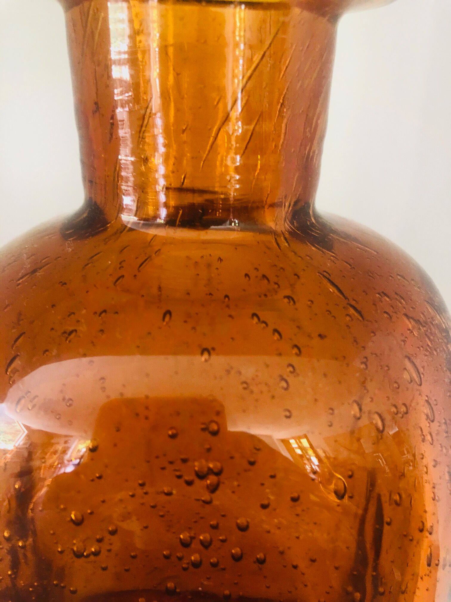 Old carafe in amber and bulled Biot glass, stamp 1496.