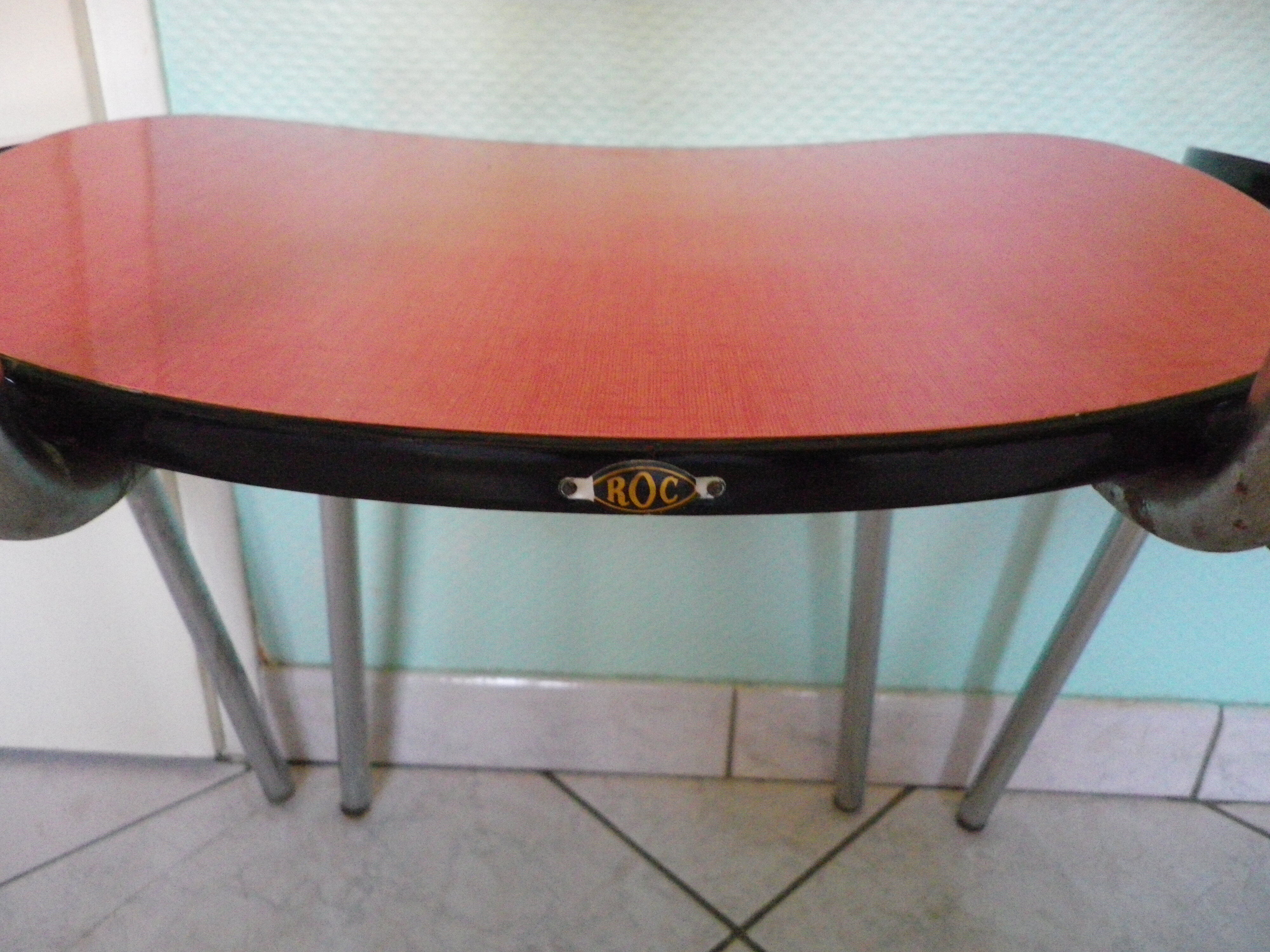 Table in red formica, 4 roc chairs, 2 extension cords, 2 drawers 60