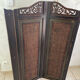Antique wooden wall panel with carving and cane in an Asian style.