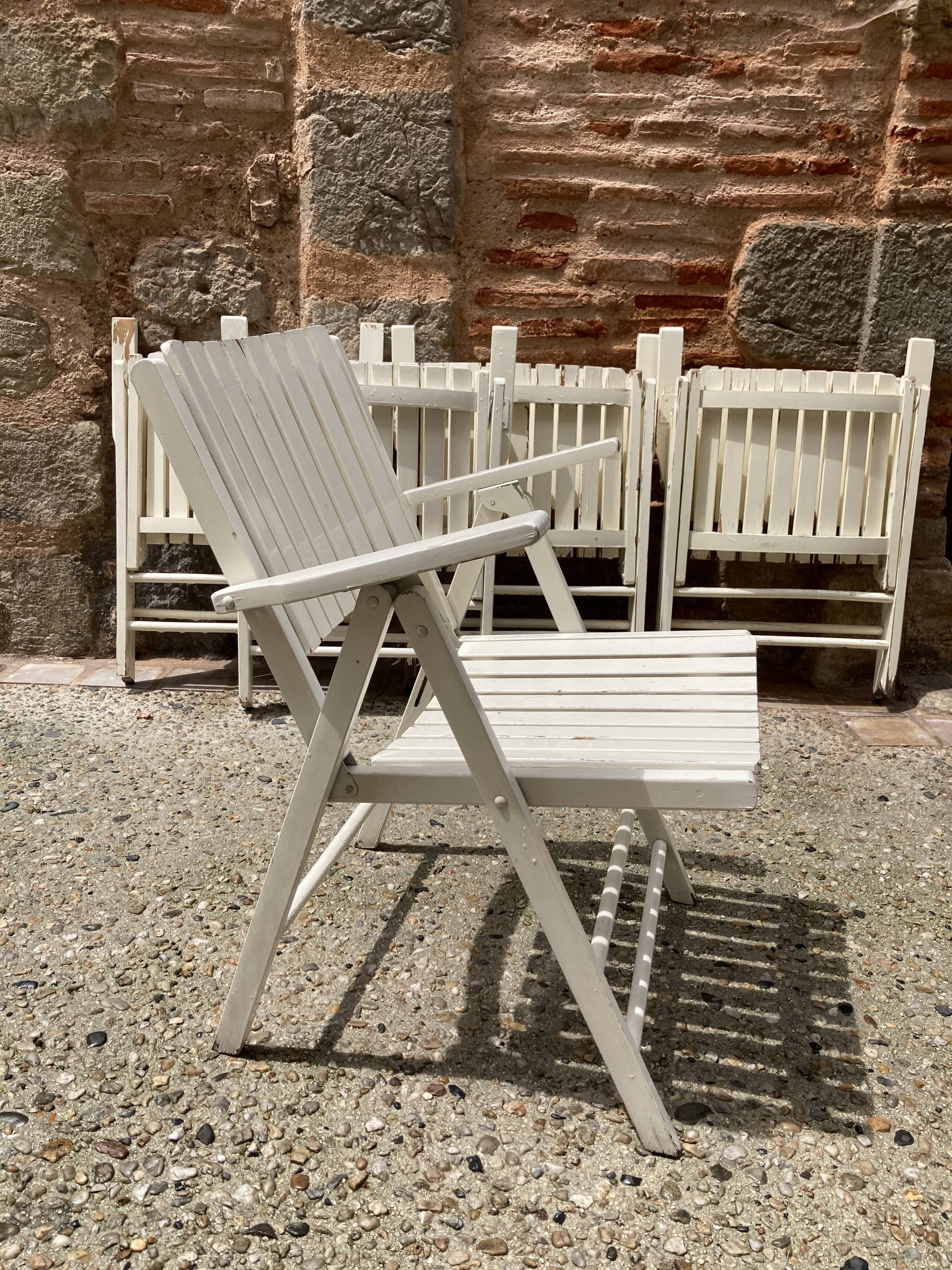 Five wooden garden armchairs