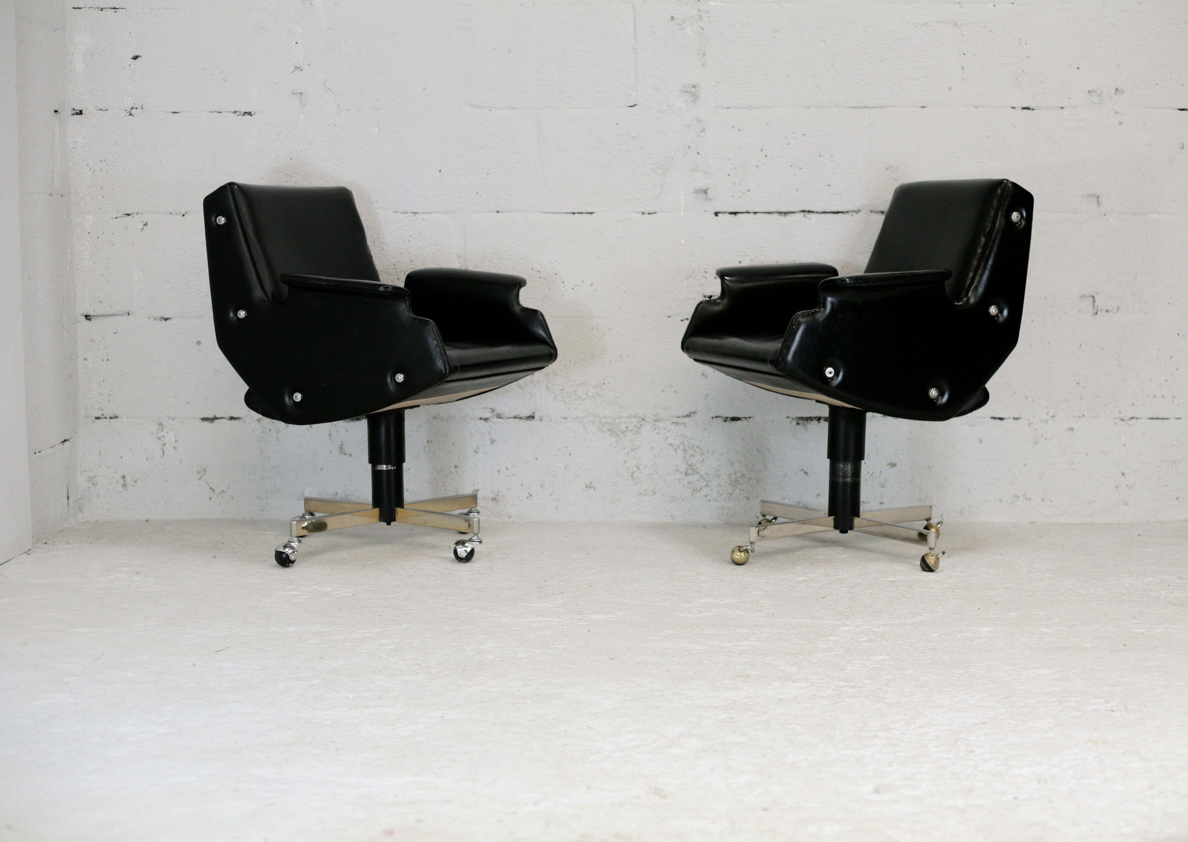 Pair of swivel armchairs, imitation leather and steel, Italy, circa 1960.