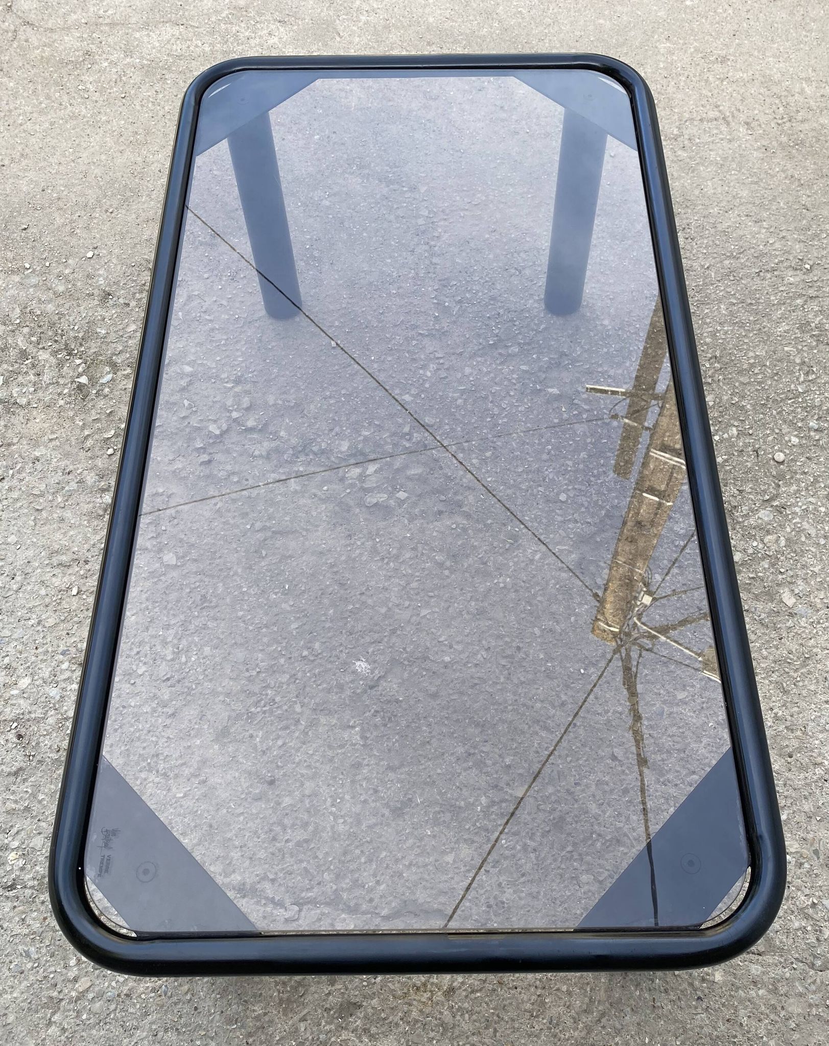 Vintage black tubular coffee table with smoked glass by Yves Boutboul, 1980.
