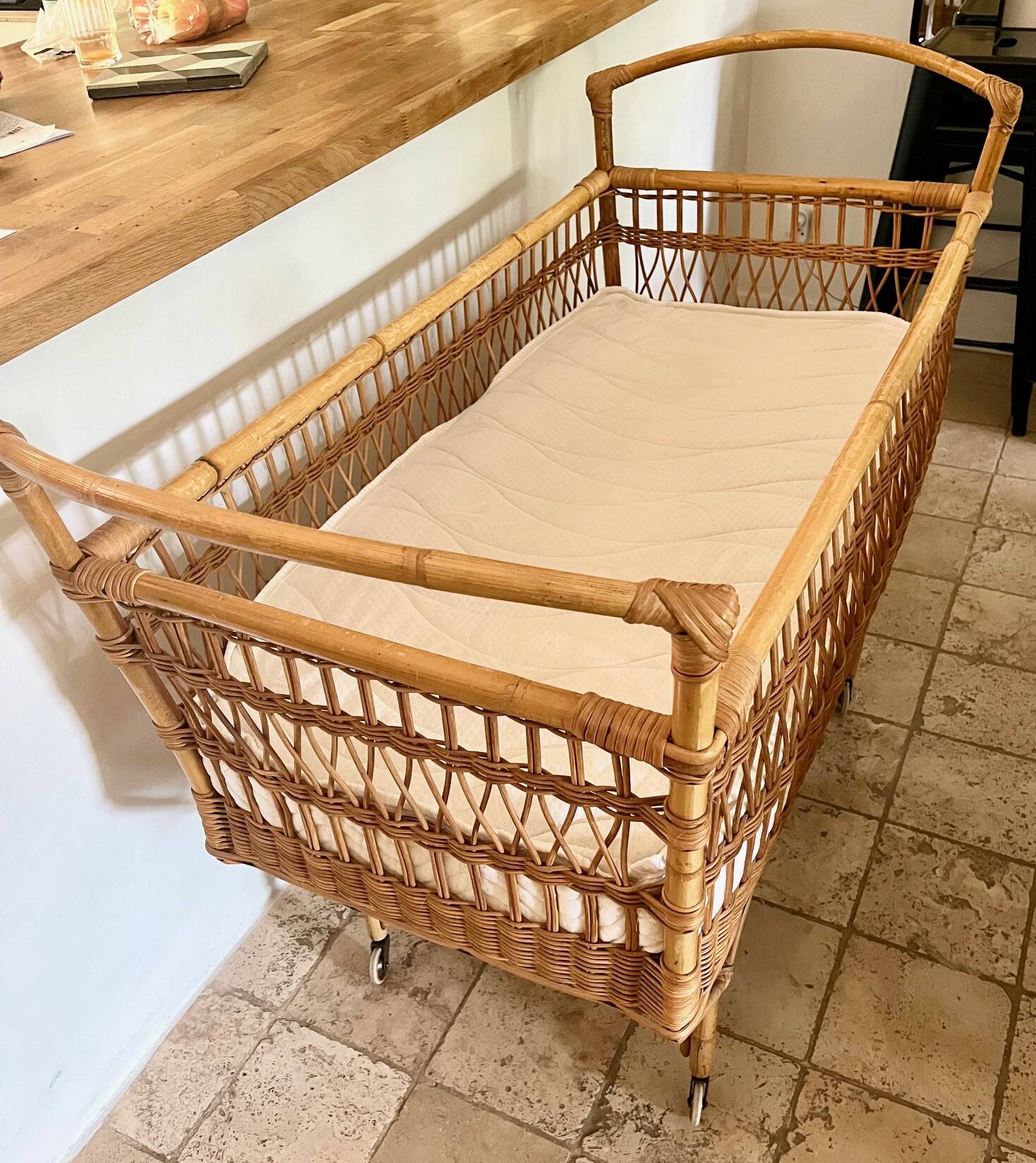 Vintage rattan baby bed with wheels