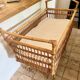 Vintage rattan baby bed with wheels