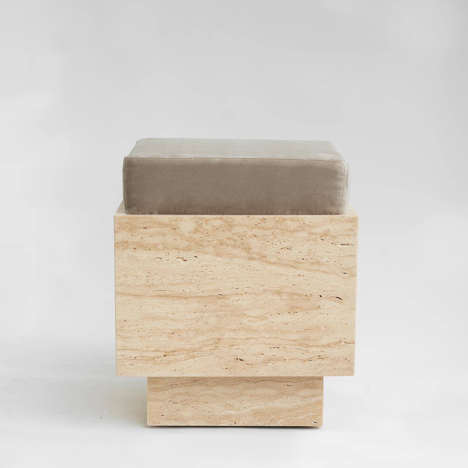 Cubic travertine stool with velvet cushion
