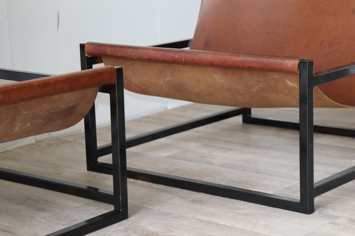 Pair of vintage armchairs in stretched leather and metal structure