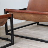 Pair of vintage armchairs in stretched leather and metal structure