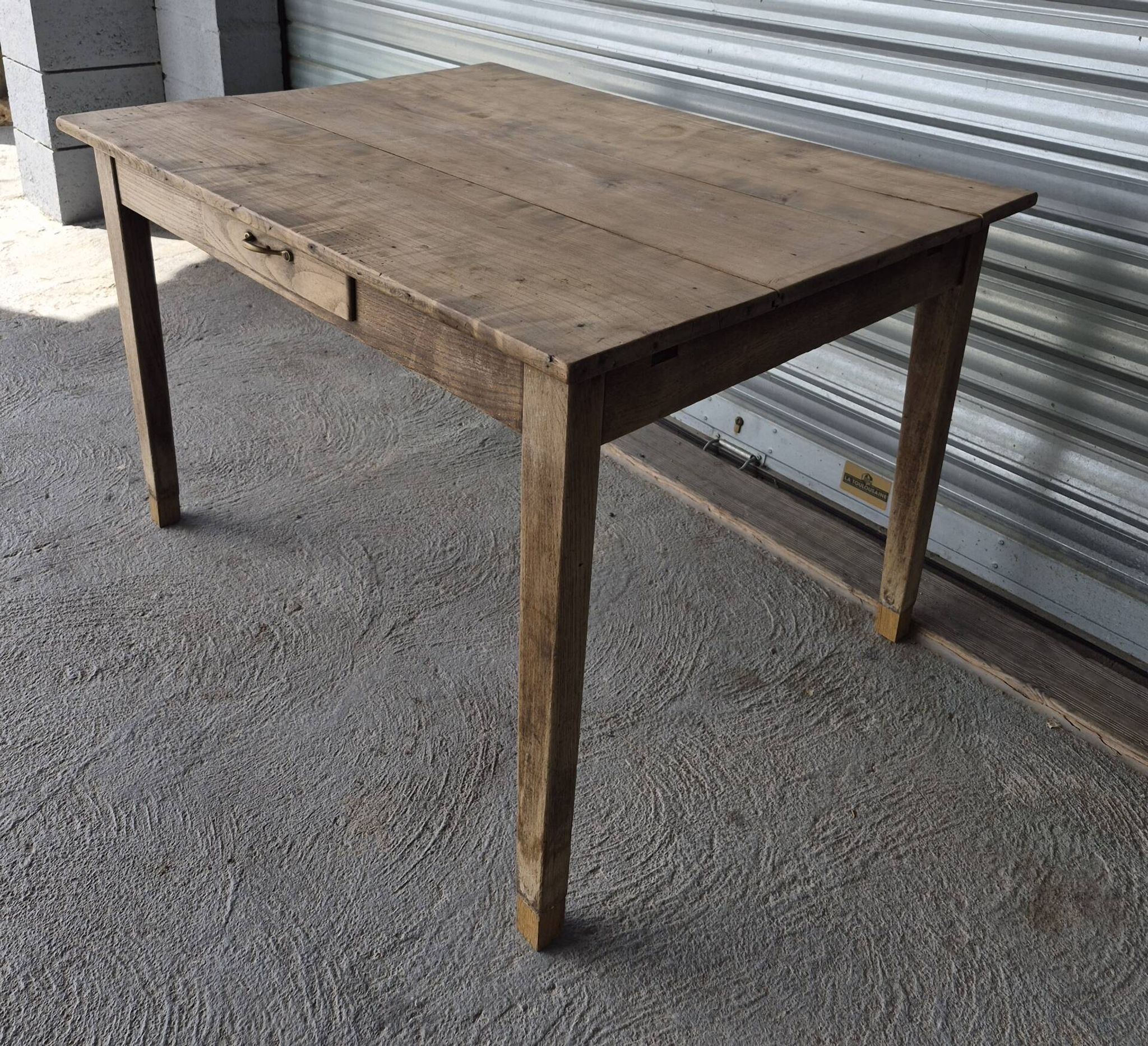 Old farmhouse table with its 2 extensions and raised legs.