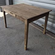 Old farmhouse table with its 2 extensions and raised legs.
