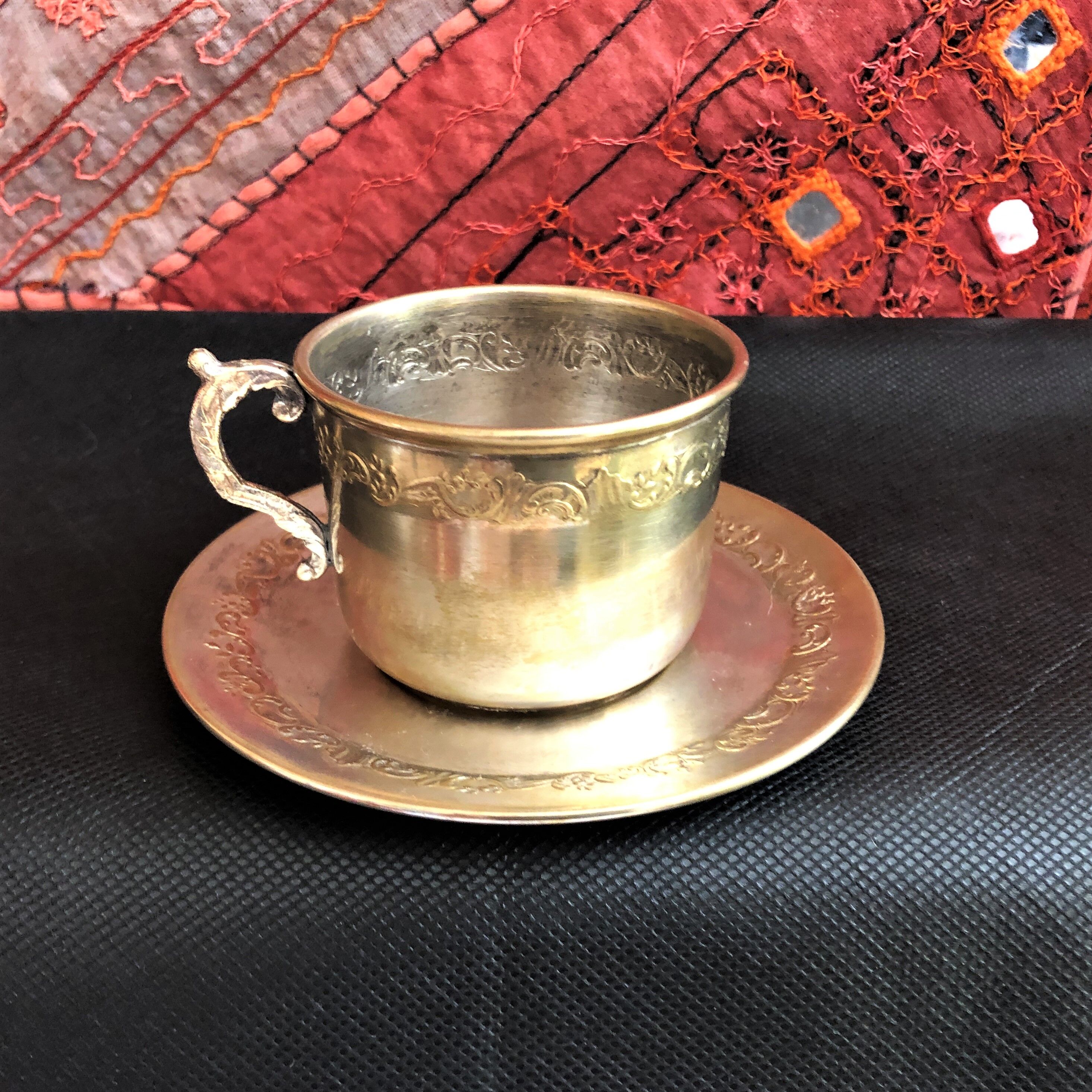 Silver metal cup and saucer