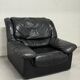 Vintage black leather lounge chair — low postmodern club chair from the space age.