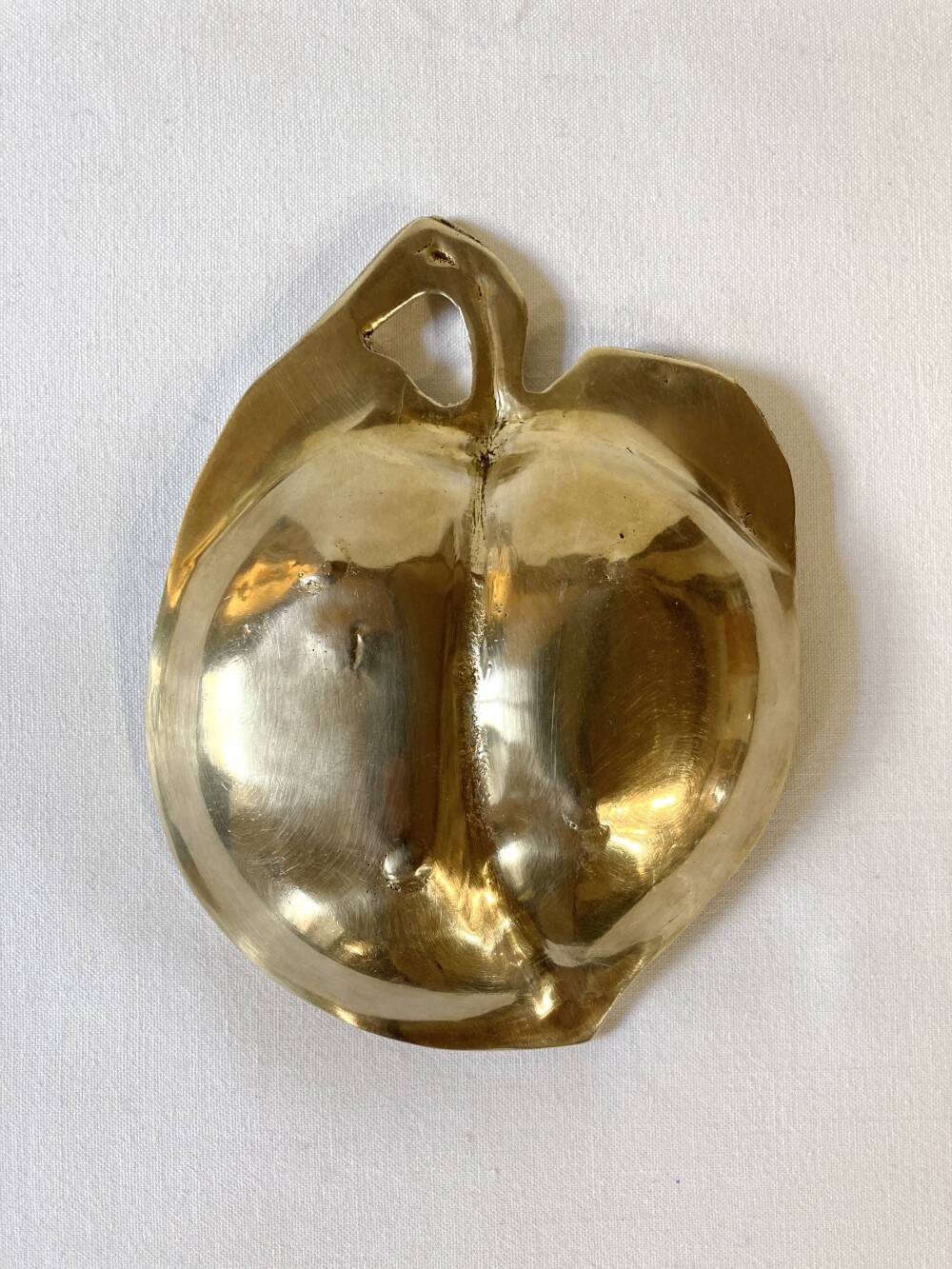 Brass catchall in the shape of an apple.