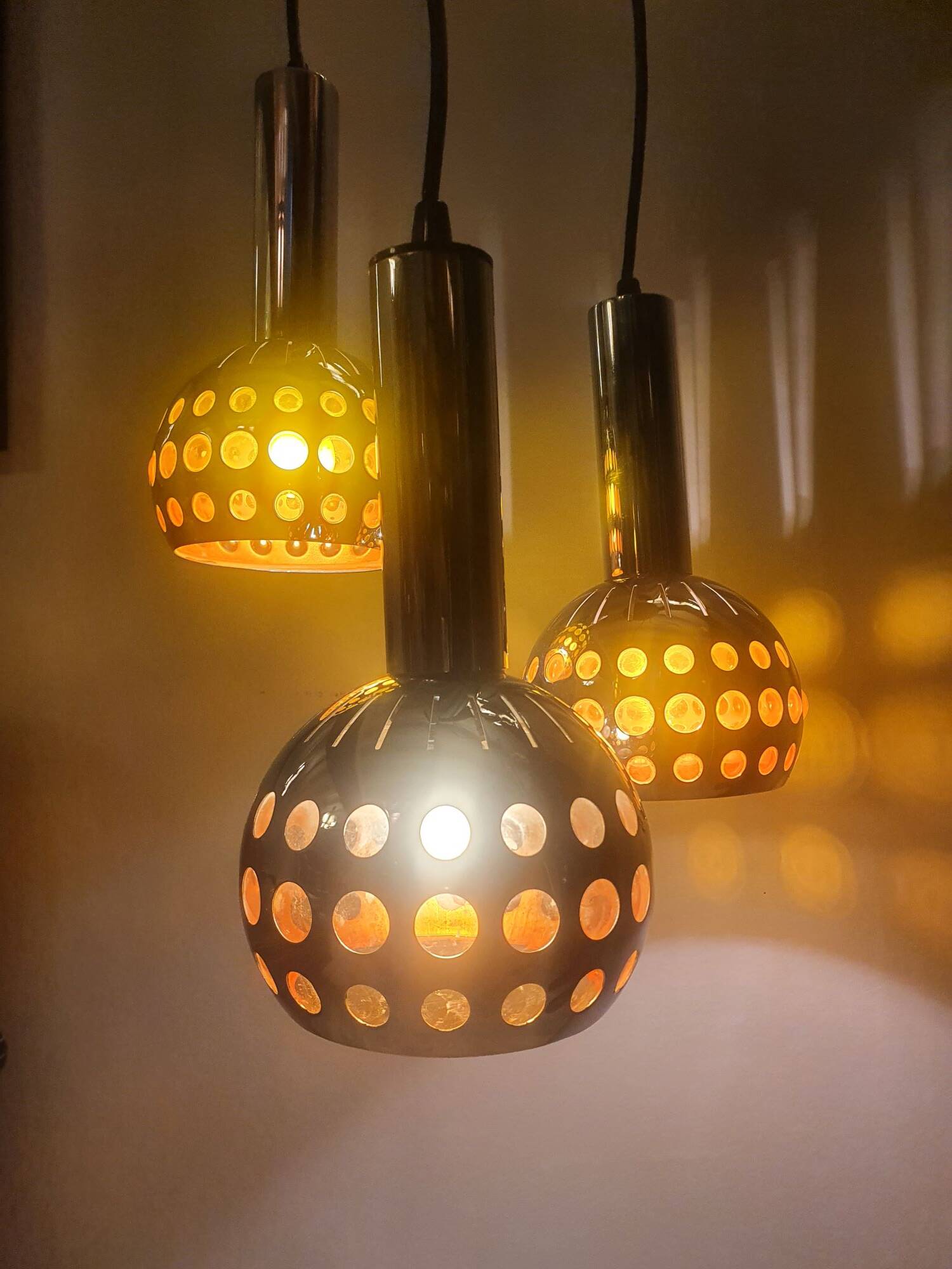 Raak three-light space age orange pendant lamp, 1970s, Netherlands