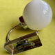 Pair of chrome metal wall lights with white glass globe.