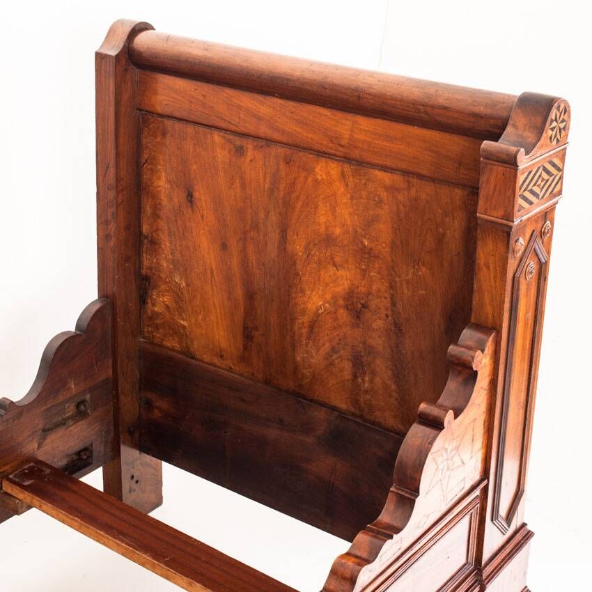 Bed made of solid walnut with marquetry details. France, 1930s.