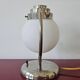 Art Deco table lamp with a spherical opaline glass shade and chrome base from the 1930s.