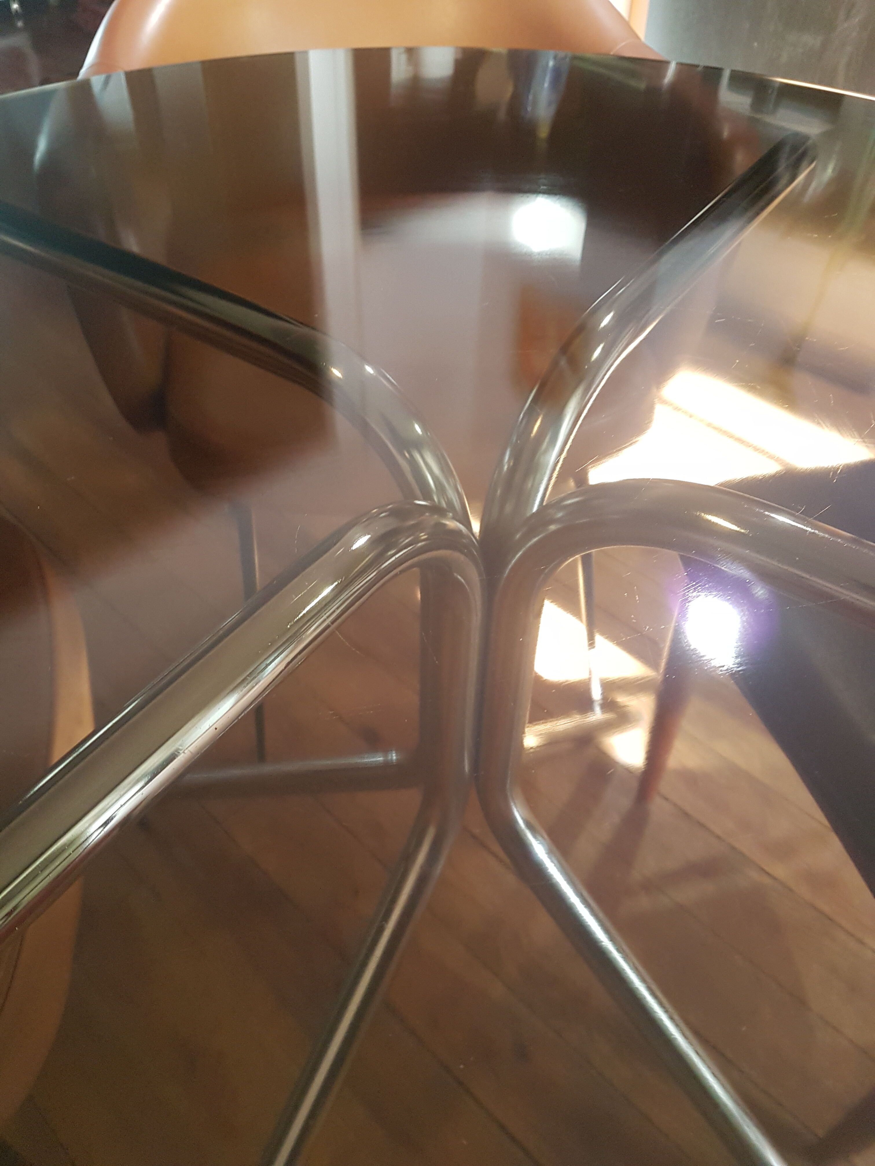 Smoked glass round table and chrome foot