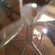Smoked glass round table and chrome foot